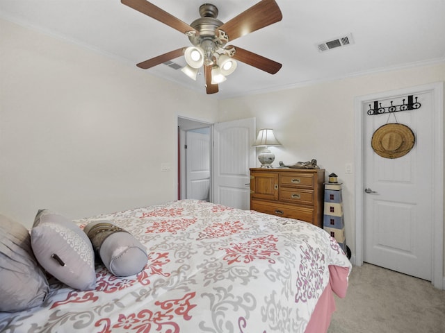 carpeted bedroom featuring ceiling fan and ornamental molding