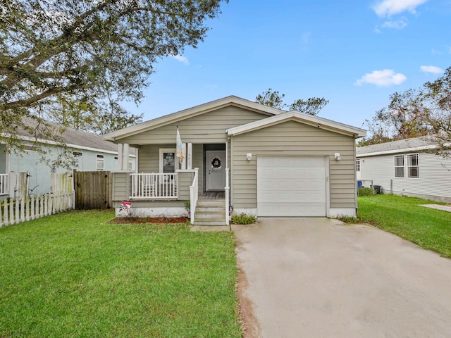 view of front facade with covered porch, a garage, and a front lawn