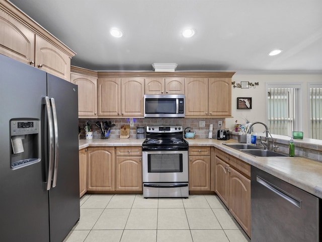 kitchen with light brown cabinetry, backsplash, stainless steel appliances, sink, and light tile patterned floors