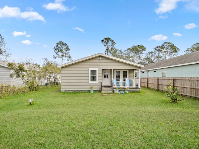 back of house with a yard and a deck