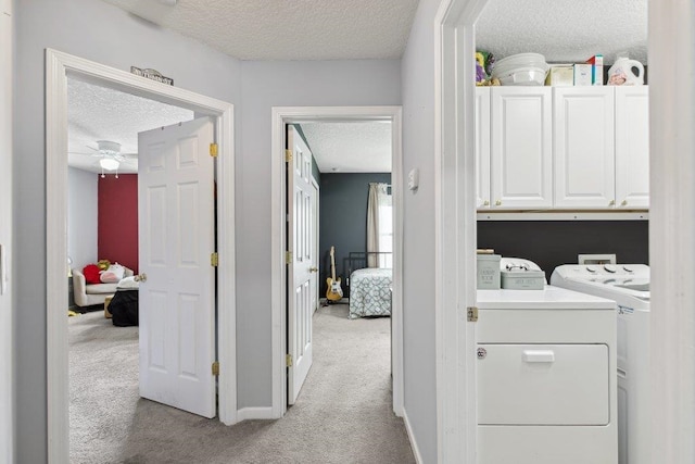 241 N Hidden Tree Dr, Saint Augustine, FL 32086 - washroom with a textured ceiling, cabinet space, light colored carpet, washer and clothes dryer, and a ceiling fan
