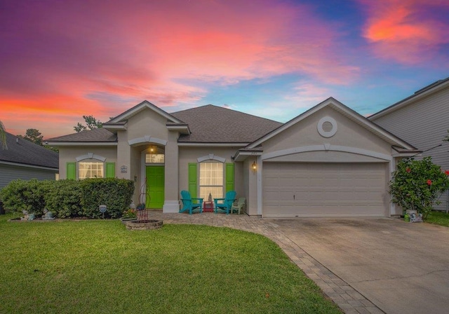241 N Hidden Tree Dr, Saint Augustine, FL 32086 - view of front of house featuring stucco siding, concrete driveway, an attached garage, and a front lawn
