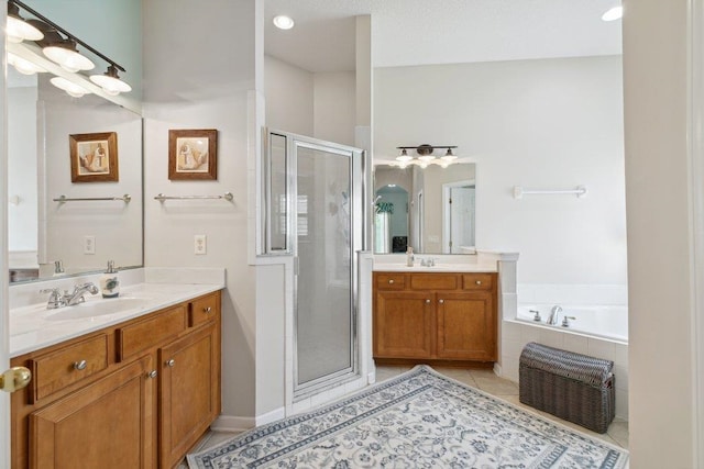 241 N Hidden Tree Dr, Saint Augustine, FL 32086 - full bath featuring a shower stall, two vanities, tile patterned floors, and a garden tub