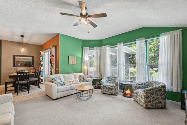 241 N Hidden Tree Dr, Saint Augustine, FL 32086 - carpeted living room with lofted ceiling, ceiling fan, and a textured ceiling