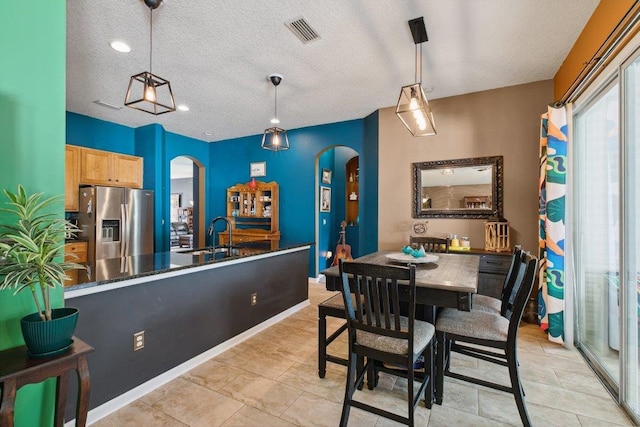 241 N Hidden Tree Dr, Saint Augustine, FL 32086 - dining area featuring arched walkways and a textured ceiling