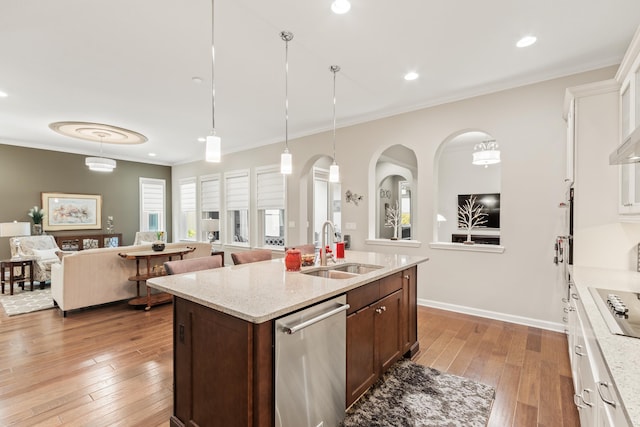 kitchen with pendant lighting, sink, light hardwood / wood-style flooring, dishwasher, and white cabinetry