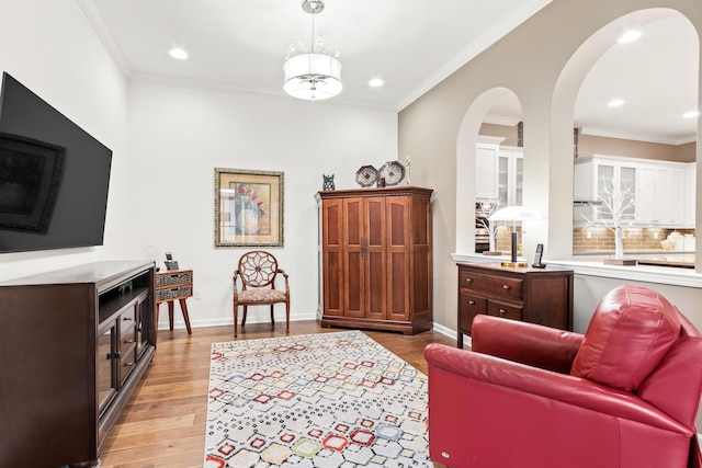 living room featuring crown molding and light hardwood / wood-style floors