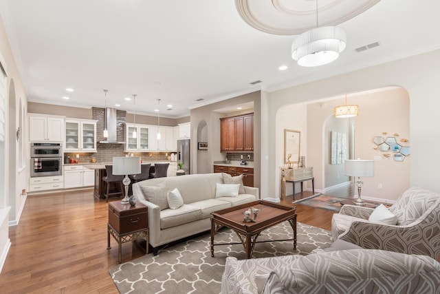 living room featuring crown molding and dark hardwood / wood-style flooring