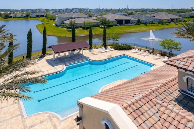 view of swimming pool with a patio, a water view, and a gazebo