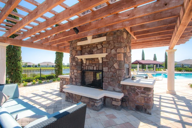 view of patio with a fenced in pool and an outdoor stone fireplace