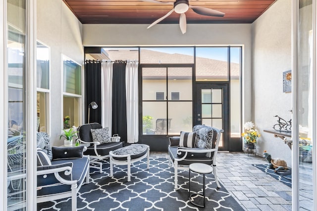 sunroom / solarium featuring wood ceiling and ceiling fan