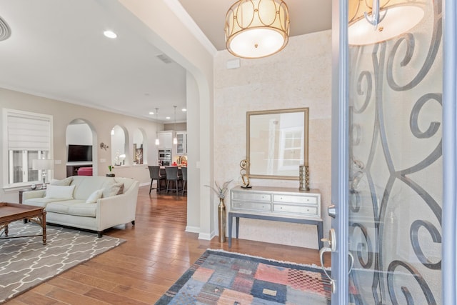 entrance foyer featuring hardwood / wood-style flooring and ornamental molding