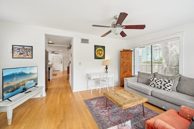 living room featuring hardwood / wood-style flooring and ceiling fan