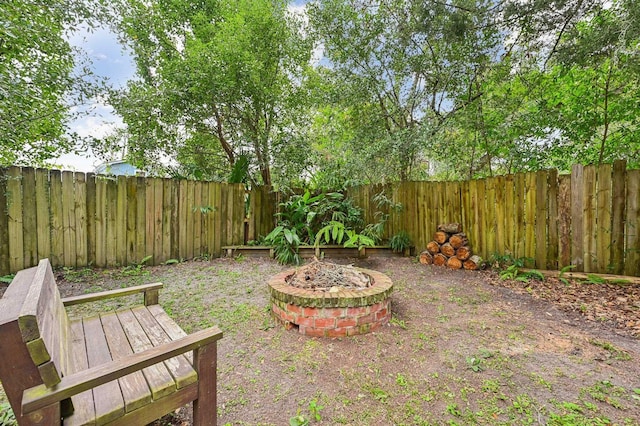 view of yard with a fire pit