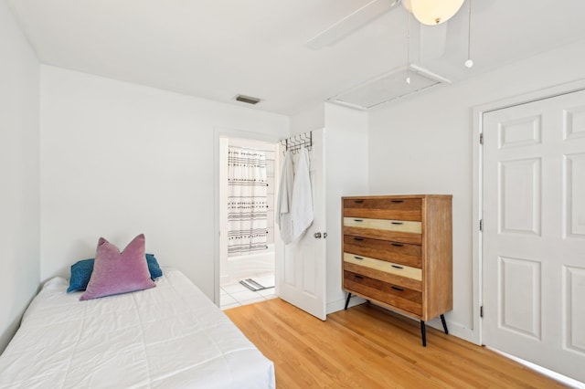 bedroom with hardwood / wood-style flooring and ensuite bath