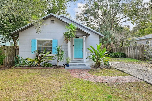 bungalow-style house with a front lawn