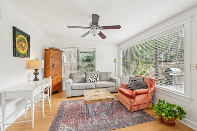 living room featuring ceiling fan and light hardwood / wood-style floors