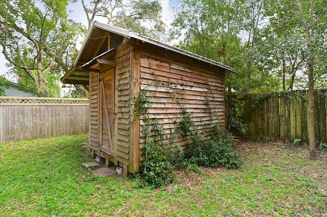 view of outbuilding featuring a lawn