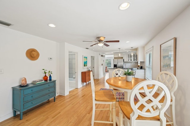 dining room with ceiling fan and light hardwood / wood-style flooring