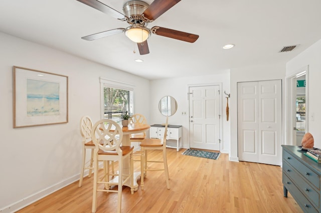 dining space featuring ceiling fan and light wood-type flooring