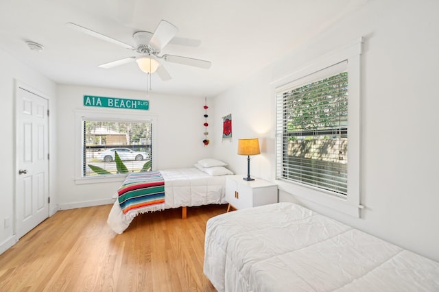 bedroom with ceiling fan and light wood-type flooring