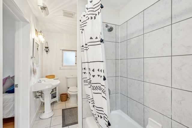 bathroom with shower / tub combo, tile patterned floors, and toilet