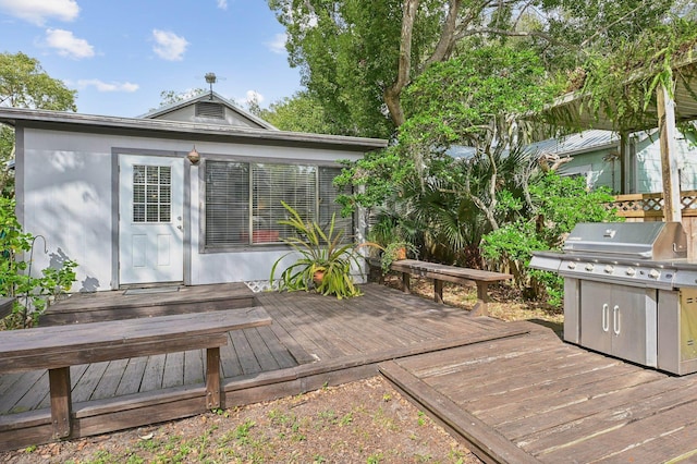 wooden deck featuring a grill