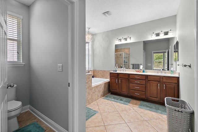 bathroom with tile patterned flooring, toilet, a garden tub, double vanity, and a stall shower