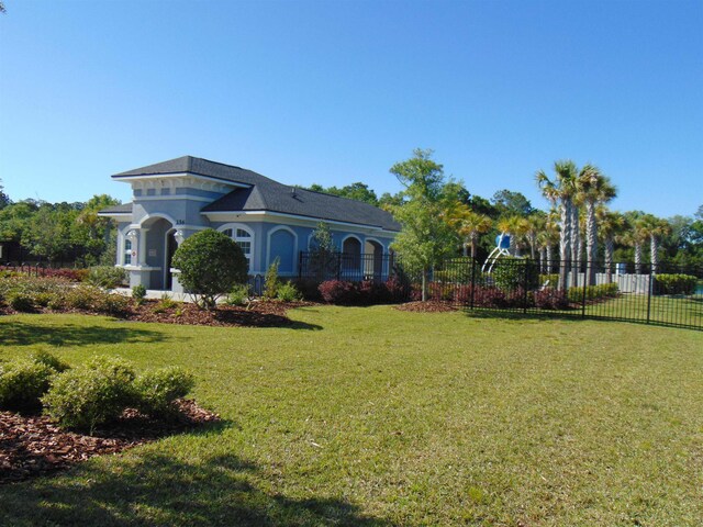 view of front of property with a front lawn and fence