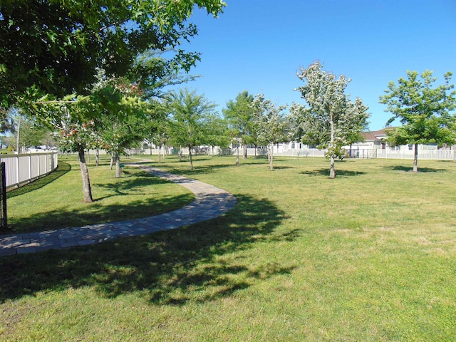 surrounding community featuring a lawn and fence