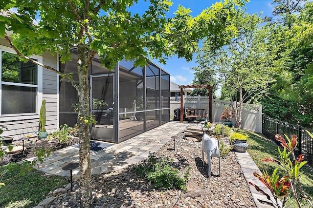 view of yard featuring a lanai, a patio area, and a fenced backyard