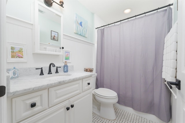 bathroom with visible vents, a wainscoted wall, vanity, and toilet