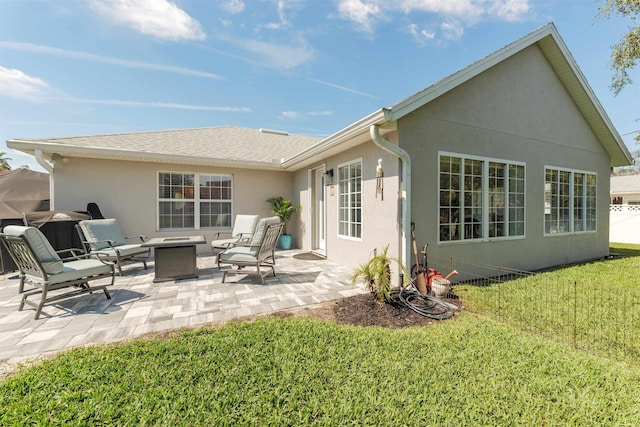 back of property featuring a patio area, roof with shingles, a lawn, and stucco siding