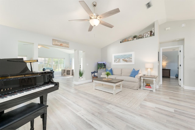 living area featuring ceiling fan, light wood-style flooring, and vaulted ceiling