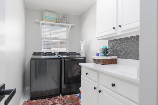 clothes washing area featuring cabinet space, separate washer and dryer, and tile patterned floors