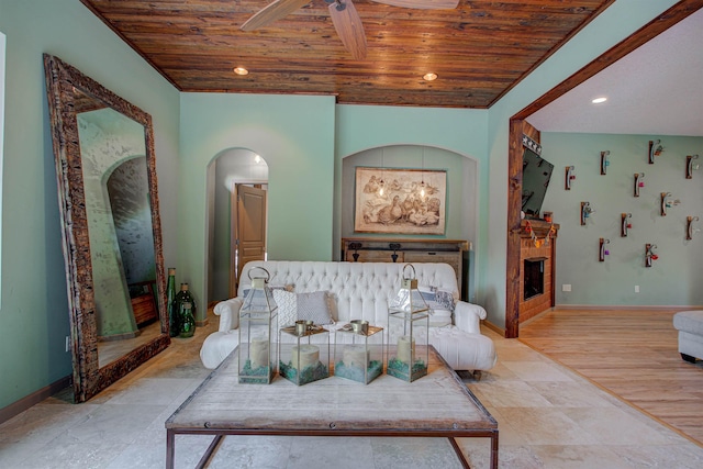 living room with recessed lighting, wooden ceiling, arched walkways, and baseboards