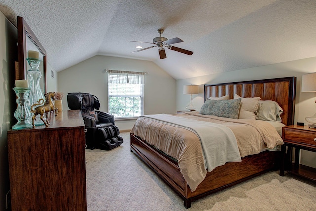 bedroom with lofted ceiling, a textured ceiling, a ceiling fan, and light colored carpet