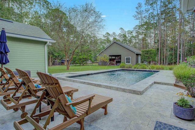 view of pool featuring a patio area and a lawn