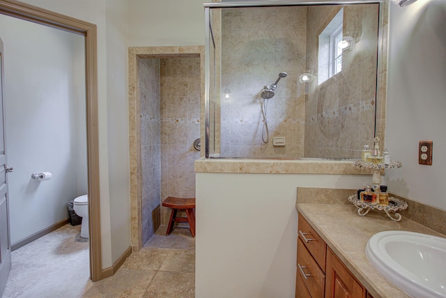 full bathroom with baseboards, vanity, toilet, and walk in shower