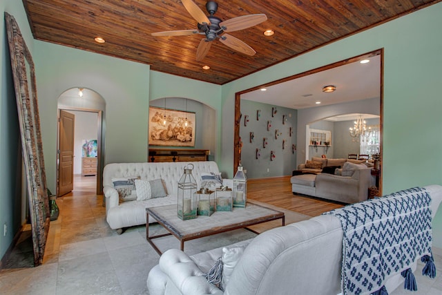 living room with ceiling fan with notable chandelier, arched walkways, wood ceiling, and recessed lighting