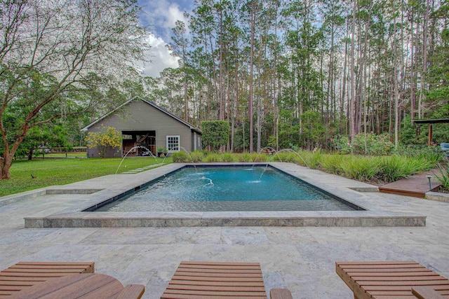 pool with a lawn, a patio area, and an outdoor structure