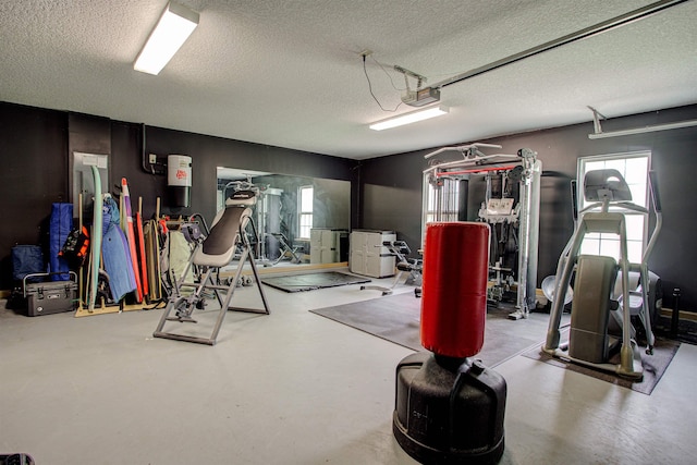 exercise room featuring a textured ceiling and a garage