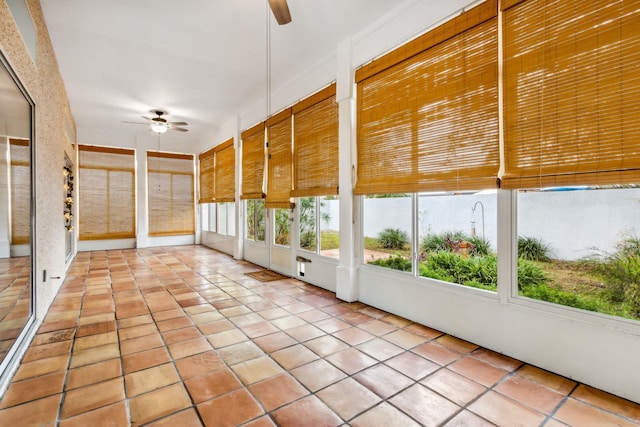 unfurnished sunroom with ceiling fan