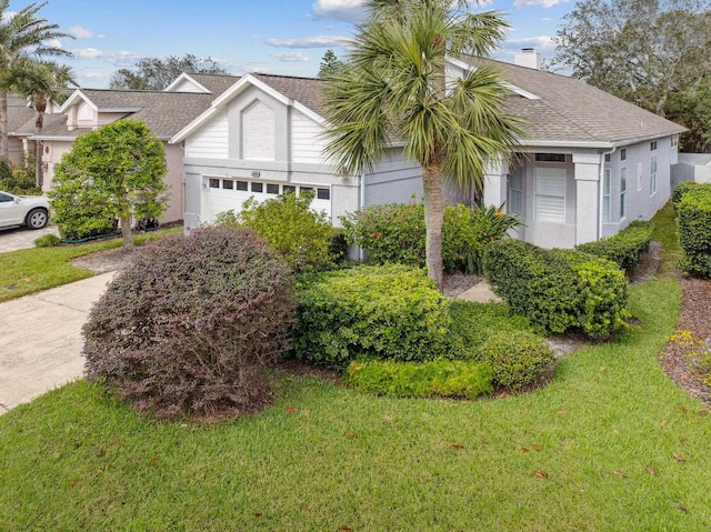 view of front of property featuring a garage and a front lawn