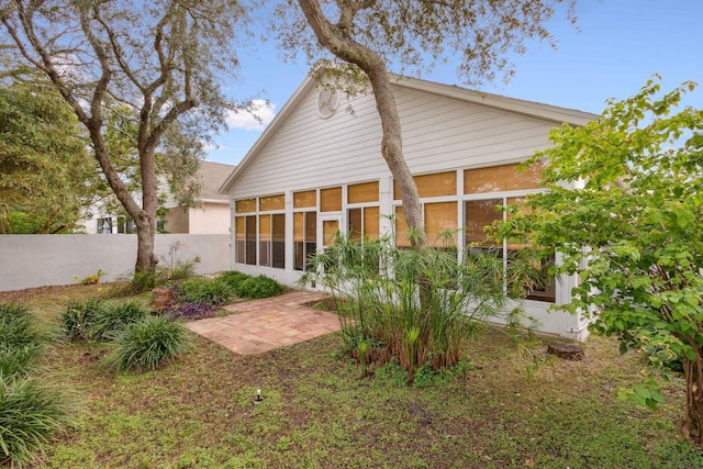 back of house with a sunroom