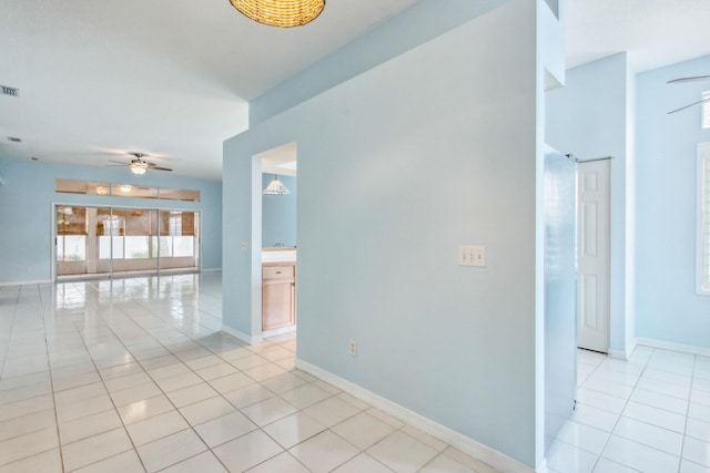 tiled empty room with ceiling fan