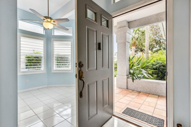 tiled entrance foyer featuring ceiling fan and vaulted ceiling