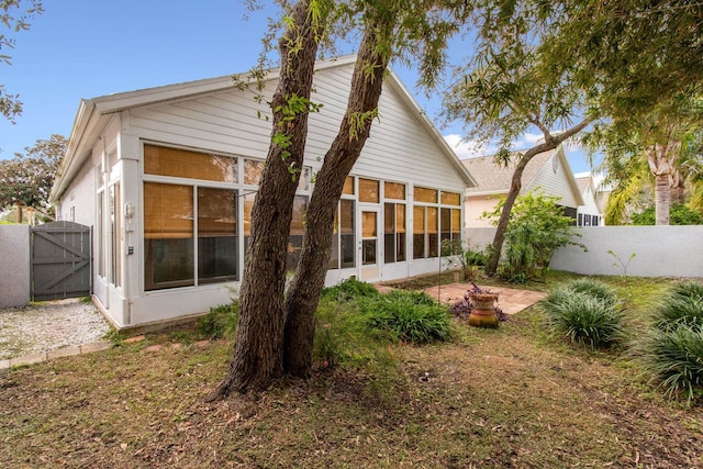 back of house featuring a sunroom