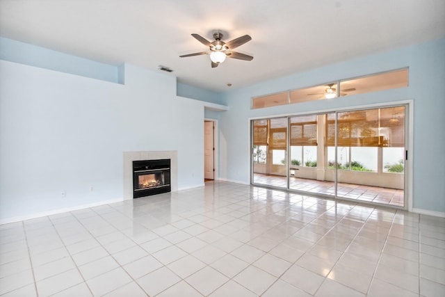 unfurnished living room featuring a tile fireplace, light tile patterned floors, and ceiling fan