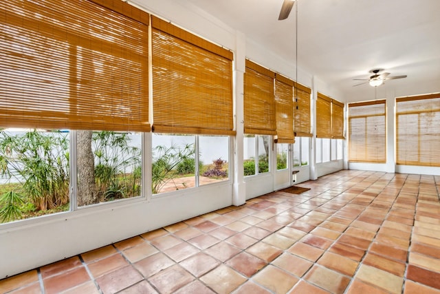 unfurnished sunroom with ceiling fan and a healthy amount of sunlight